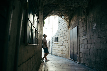 Fototapeta na wymiar man standing in tunnel in kotor town