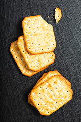 Food appetizer salted Crackers on black slate board with copy space
