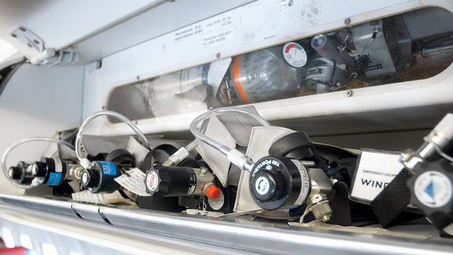 Closeup image of emergency oxygen cylinders, valves and pipes on modern jet aircraft