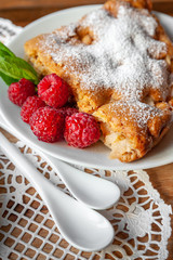 Apple pie with fresh raspberries and mint on a wooden background. Selective focus, romantic breakfast, healthy eating.