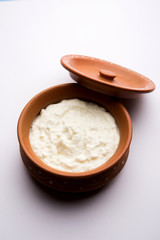 Plain curd or yogurt or Dahi in Hindi, served in a bowl over moody background. Selective focus