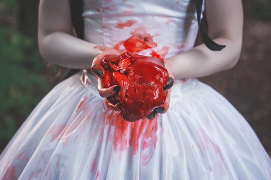 Bloody raw meat in hands. Halloween concept