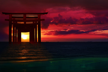 Fototapeta premium silhouette torii wooden Japanese pillar stand on over the sea and sunset sky