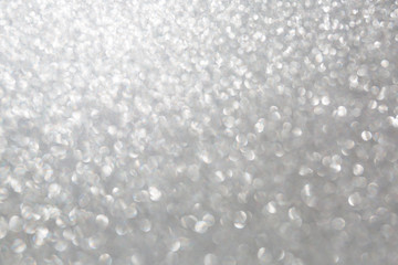 The Glittering glitter background with a bokeh.