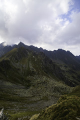 Obraz premium Landscape with rocky mountain peaks in summertime