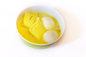 Terik, tofu and chicken egg soup with coconut milk and turmeric.