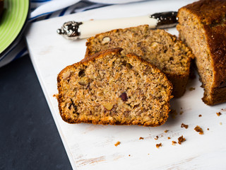 Whole grain banana bread for breakfast on white wooden board