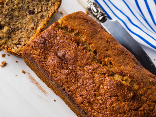 Whole grain banana bread for breakfast on white wooden board