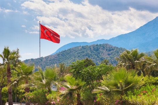 Turkish flag over the mountain view and cloudy sky