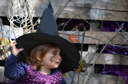 Little witch,A girl in a witch costume,Girl dressed as a witch in the forest with hat, halloween.