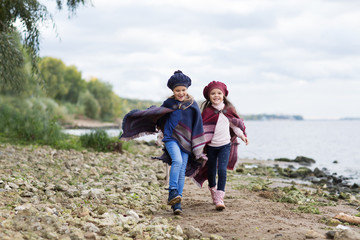 Two little girls sisters playing and  having fun together outdoors