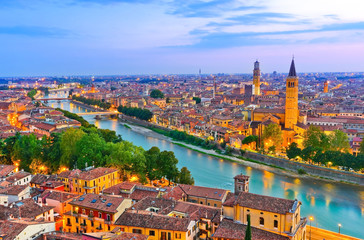 Fototapeta na wymiar View of the historic city center along Adige river at dusk in Verona, Italy.