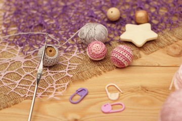 Colorful yarn, crochet hook on wooden background
