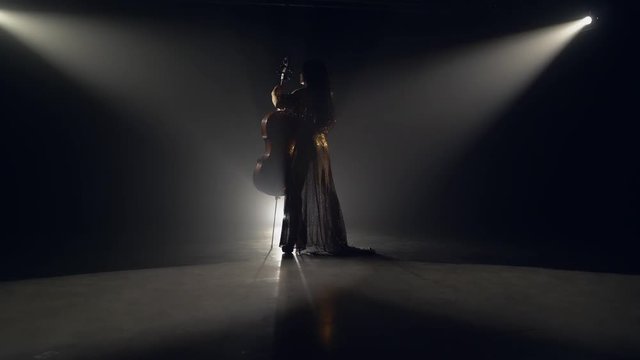 The cellist performs on stage.