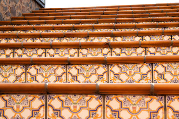 Close-up view of some steps of a Stairs with beautiful colorful ceramic tiles with pattern.
