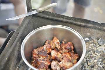 Fire-roasted chunks of pork are in the pot