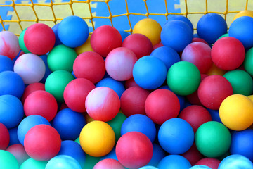 Fototapeta na wymiar Many colour plastic balls from children's small town
