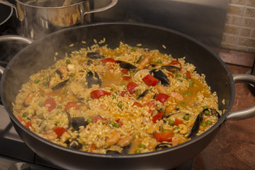 horizontal image of a pan on fire during the preparation of the paella