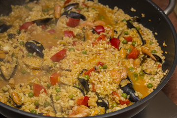 horizontal image with food detail of paella preparation