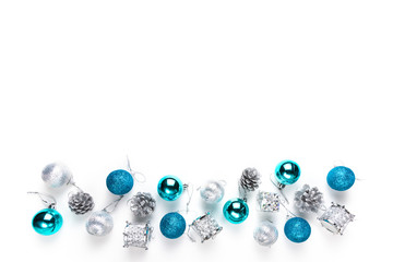 Christmas tree decorative ornaments of silver star, blue balls, pine cone and small drums over white background with copy space for winter Merry X'mas text insertion, logo or product decoration on new
