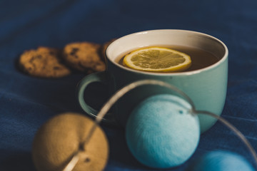 Tea with Lemon and Cookies with Chocolate Laying on Mattress