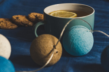 Tea with Lemon and Cookies with Chocolate Laying on Mattress