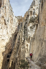 One person in the amazing famous "Caminito del Rey" a path at 100m above the ground on a steep gorge called "Desfiladero de los Gaitanes", best trekkings in Andalusia and Spain, an awesome adventure