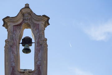 horizontal image of an ancient bell tower with the sky in the background