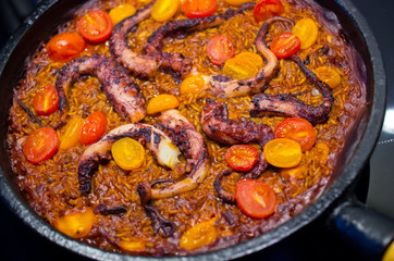 Paella with octopus on the pan