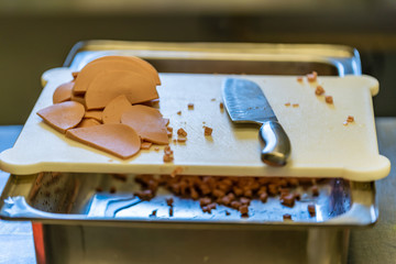 Cutted Slices of Ham, Laying on Table, with The Knife in the Background