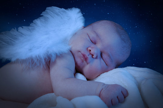 Sleeping newborn with wings