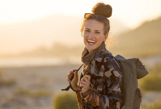 tourist woman against mountain and sea landscape at sunset - Powered by Adobe