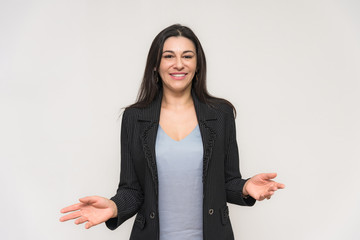 Portrait of a beautiful brunette woman on a white background with different emotions. She stands directly in front of the camera