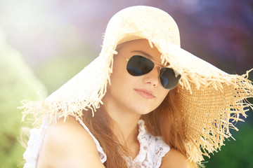 Young woman with sunglasses and hat. Outdoor portrait