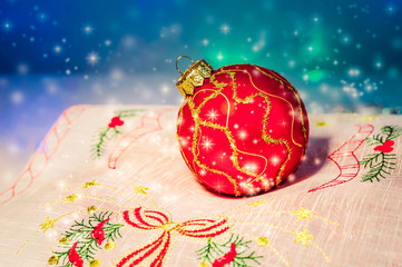 Red Christmas ball on a napkin. Christmas decorations.