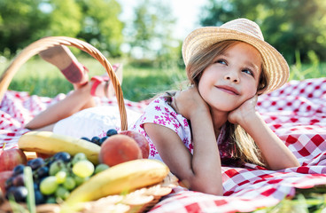 Little girl enjoying picnic in the park. Nature, lifestyle
