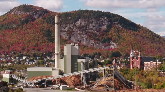 Power Plant and Smoke Stack with small town New England, USA, in the background, Peak Autumn Foliage, Inspire 2 Telephoto Aerial