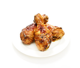 grilled chicken legs with sesame  in a  plate on a white background