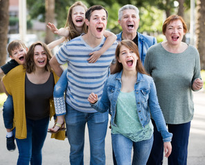 Friendly family going in the park on weekend