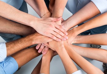 Top View of People in Circle with Their Hands Together