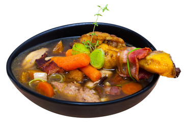 Scottish traditional soup of chicken, bacon and leek, served in bowl