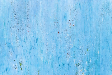 Old painted blue metal surface with cracks and rust