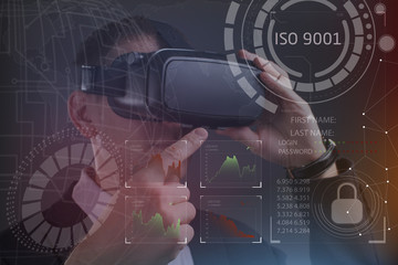 Business, Technology, Internet and network concept. Young businessman working in virtual reality glasses sees the inscription: ISO 9001