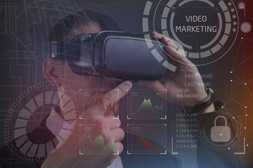 Business, Technology, Internet and network concept. Young businessman working in virtual reality glasses sees the inscription: Video marketing