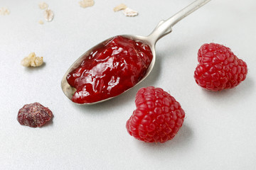 Spoon with raspberry jam.
