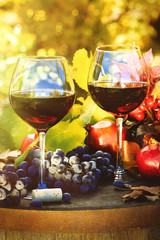 Fall scene with glasses of red wine and grapes