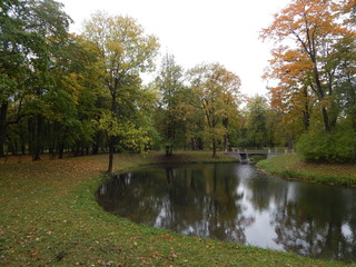 Fototapeta na wymiar Autumn landscape with water and a bridge