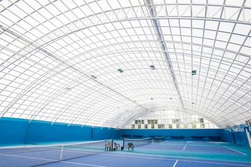Poster Background shot of modern indoor tennis court interior with glass dome, copy space © Seventyfour