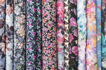 Samples of fabric - printed cotton of different colors with flowers on the display case