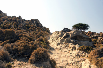 Fototapeta na wymiar A rocky path in the hills in the island of Patmos, Greece